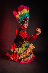 Matlachines Dancer from Coahuila Mexico A man in a colorful costume is holding a drum