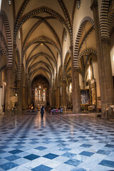 Nave with Gothic arches and Corinthian columns and altar of Santa Maria Novella church, Florence...
