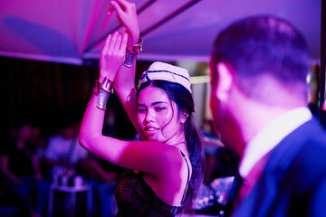 Music, dance and Asian woman in nightclub with neon lights at disco event, celebration or concert....