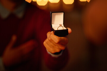 Person, hand and ring box for engagement proposal for marriage question at night, romantic or...
