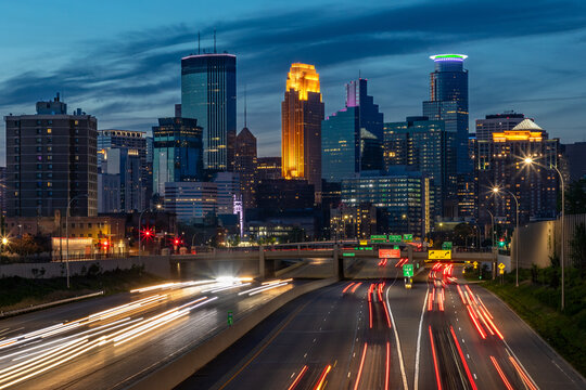 The lights of the Minneapolis Skyline come alive in Minnesota as daylight fades and a busy city adds vibrance to this growing Midwest city