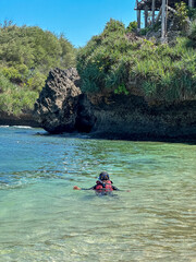 indonesian young woman in hijab swimming snorkeling enjoying holiday at the beach