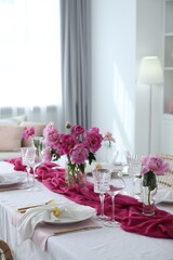Beautiful table setting with pink peonies in dining room