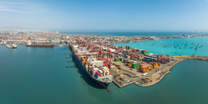Aerial view of the port of Callao in Lima, Peru, showing port activity with containers and cranes in full operation. In the background can be seen the city and the Pacific Ocean