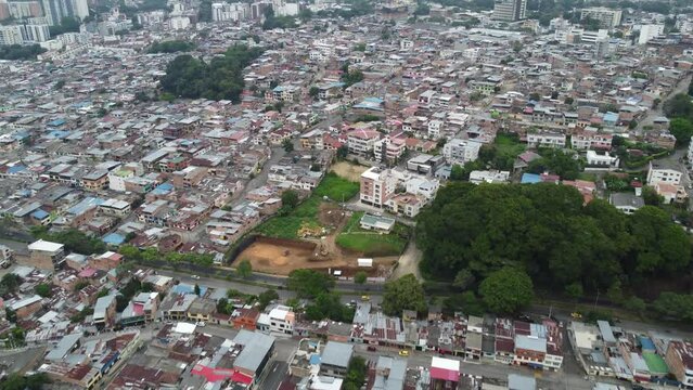 aerial video taken with a drone of a panoramic view of the city on a cloudy day where the horizon is lost between clouds and mountains