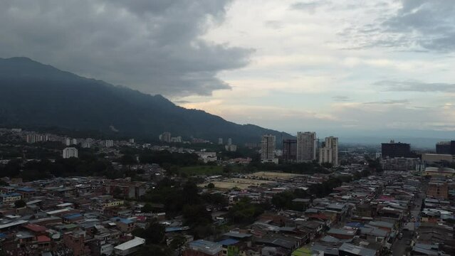 aerial shot in ascending motion of the city that is lost in a cloudy horizon,