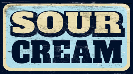 Aged and worn retro sour cream sign on wood