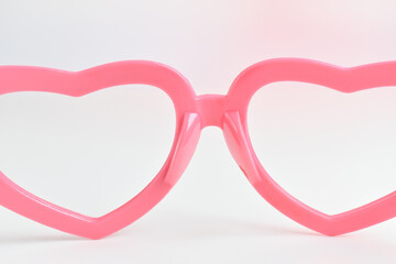 pink heart shape of glasses on white background