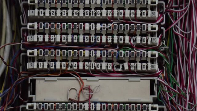 Inside a PABX telephone booth that has a number of connecting cables in many colors in the analog system. communication technology
