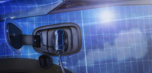 EV charging charges an electric car reflection of a solar panel