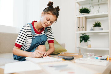 Naklejka premium Happy Teenage Girl Painting a Cute Portrait of a Colorful Picture