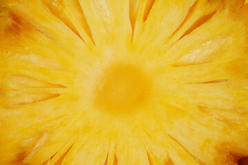 Summer fruit background concept, macro shot of juicy yellow pineapple slice texture