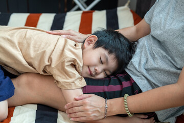 Little Asian child showing love to his mother by hugging