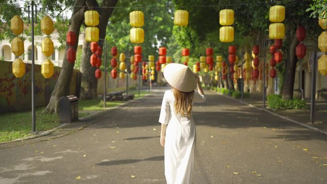 Portrait of Asian Vietnamese woman girl in local temple with light lanterns festival traveling in Hanoi urban city town, Vietnam. People lifestyle.
