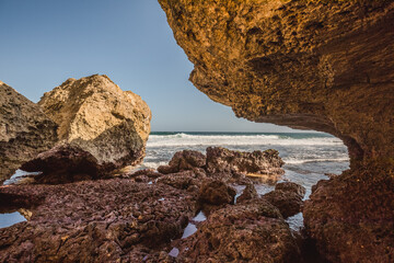 Fototapeta premium rocks on the beach ; beautiful nature with clear blue sky ; rocky indonesian beach