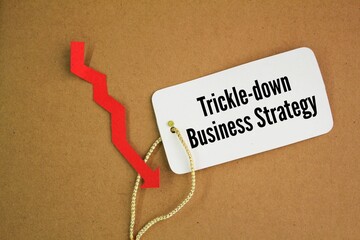 red arrow and paper tag with the word trickle-down business strategy