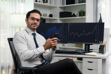 Profile of successful in smiling trader businessman looking at camera with holding phone two stock...