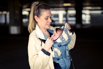 Sideview portrait of a happy woman looking and smiling to her baby