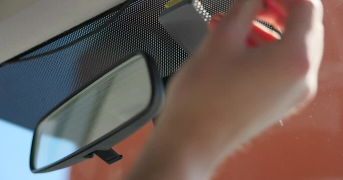 Hands attaching cables to front camera car recorder attached to windscreen