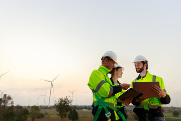 Engineer wearing safety uniform using tablet discussed plan about renewable energy at station...