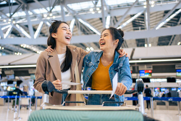 Asian young women passenger walk in airport terminal to boarding gate. 