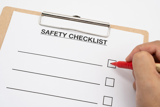 Blank checklist paper during safety audit and risk verification. safety checklist form on white background with red pen.