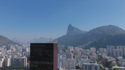 Aerial footage rotating around the skyscrapers in Botafogo with the Christ the Redeemer statue in the background.