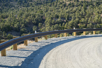 Curve overlooking steep drop with guard rail.  