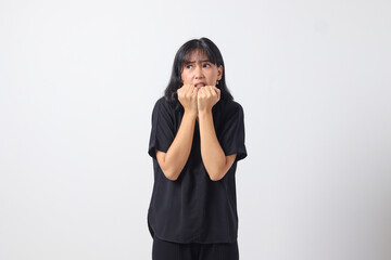 Portrait of attractive Asian woman in casual shirt making shocked hand gesture, showing surprised and scared expression. Isolated image on white background