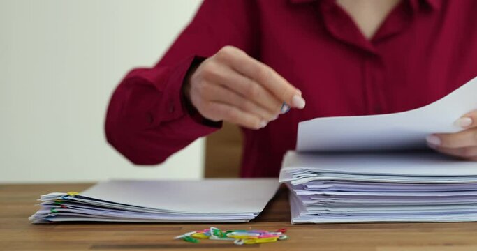 Woman sorts documents on a table time lapse