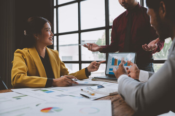 Group of business people, investors talking and meeting using documents and laptops to analyze and discuss. Presentation of financial report situation in the office. Teamwork concept, startup business