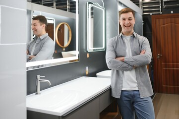 Middle age man choosing bathroom sink and utensils for his home