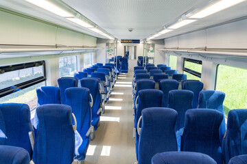 Fototapeta premium Short- and long-distance passenger train with blue seats without people. Selected focus.