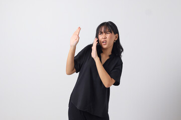 Portrait of attractive Asian woman forming a hand gesture to avoid something. Advertising concept....