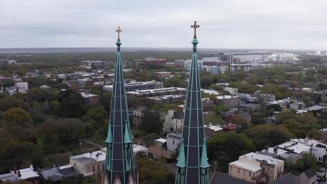 Aerial parallax panning shot of the gothic spires atop the Cathedral Basilica of Saint John the Baptist in Savannah, Georgia. 4K