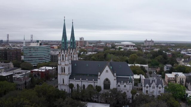 Low panning aerial shot of the historic Cathedral Basilica of Saint John the Baptist in Savannah, Georgia. 4K
