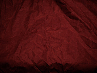 Wrinkled paper texture in dark red tones for a mysterious background.      