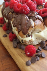 Hot cross buns with raspberries, cream cheese and chocolate melts. 