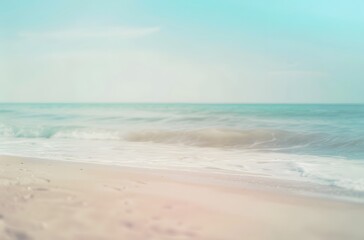 Blurred Background of a Sandy Beach with Waves and Blue Sea