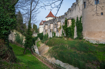 Moat of Bojnice Castle with stone walls.