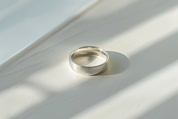 close-up of a silver wedding ring on a white background