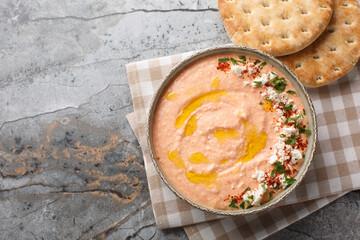 Greek Tirokafteri spread is a  spicy feta dip with feta cheese, roasted red peppers, garlic and...