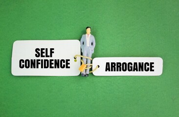 miniature people and paper with two choice words self confidence or arrogance