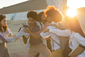 Young Friends Playfully Interacting Outdoors at Sunset