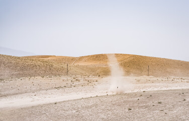 A dust whirlwind turns into a tornado in a desert area in Tajikistan, a wind tornado