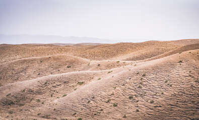 Panoramic landscape of hills with dry yellow grass in Tajikistan, sun-dried hills