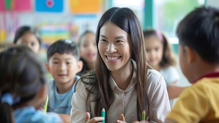 An Asian teacher smiles while engaging with young students in a colorful classroom, representing education, learning, and positive interaction.