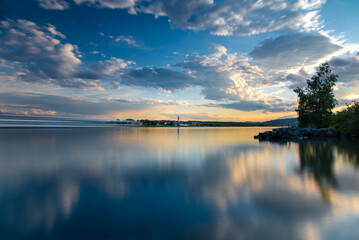 Calm sunset scene in the blue hour time on the Danube river with long exposure water and beautiful...