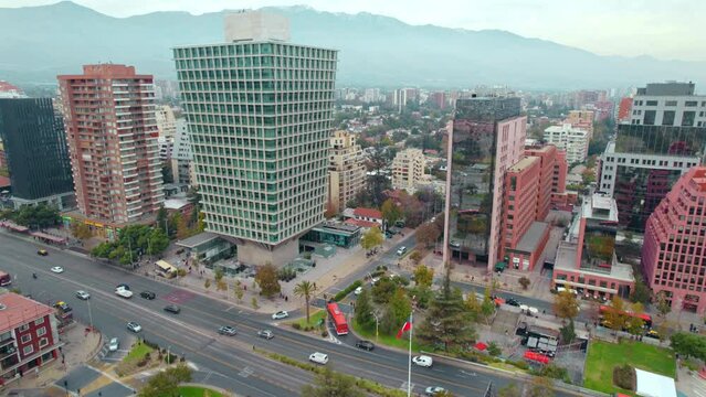 Drone flyover toward SCL Apoquindo building, Modern picturesque Architecture, Santiago foggy Cityscape, Chile 