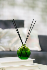 Aroma diffuser bottle with sticks in living room